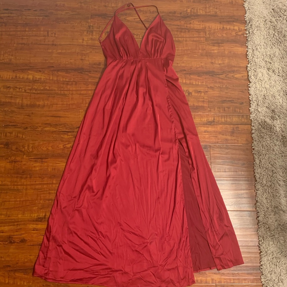 Red silky formal dress, with an open back.